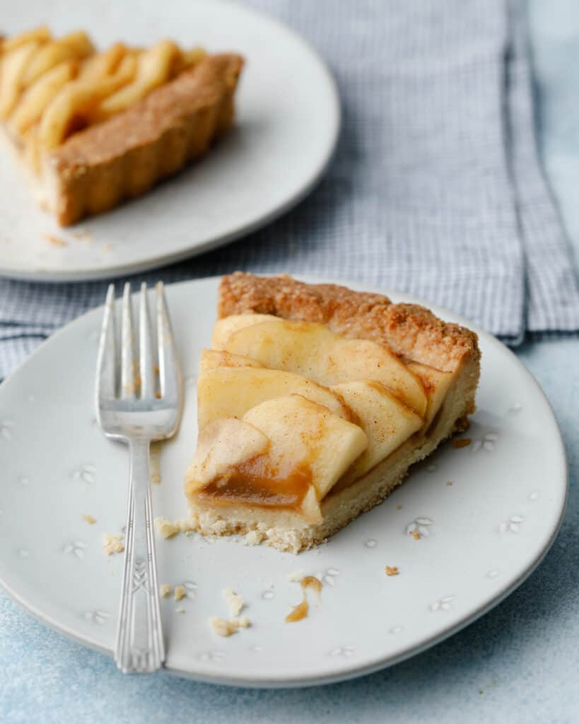 A slice of the apple butter tart with a bite missing
