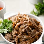 Pulled Pork Carnitas in a serving bowl with fresh cilantro