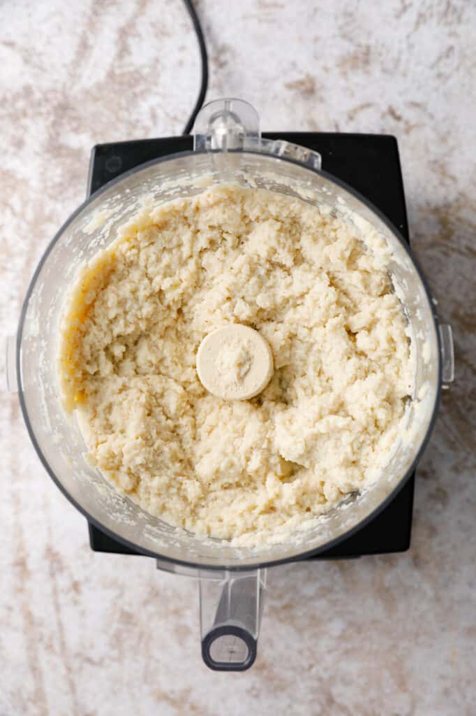 overhead view of a food processor with cauliflower mash inside