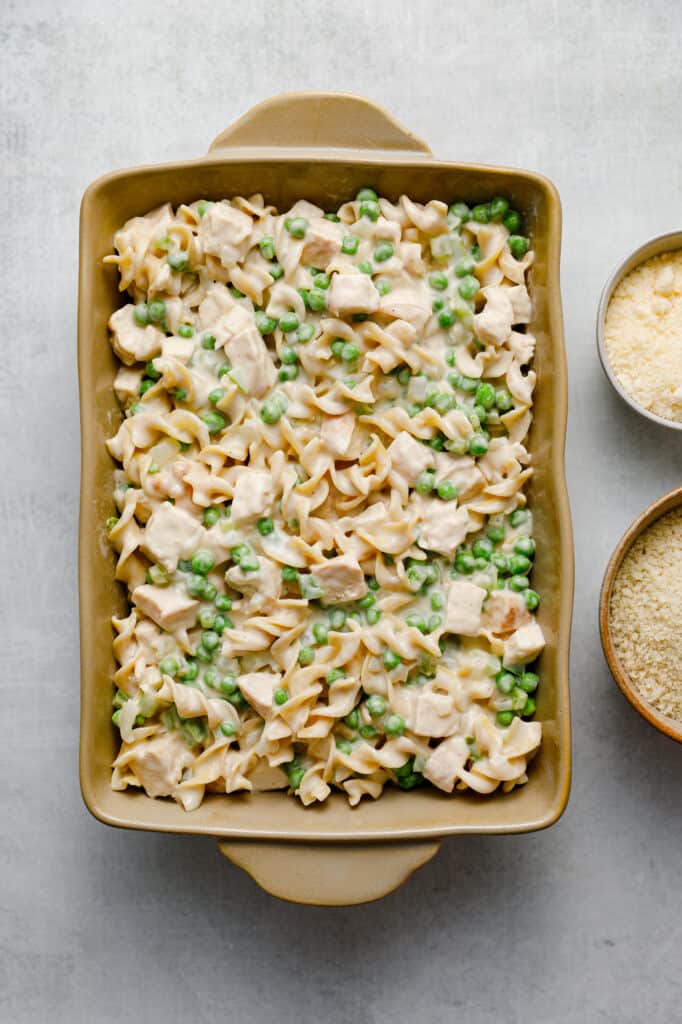 Add the ingredients together and dump them into a baking dish to then top with parmesan panko breadcrumbs