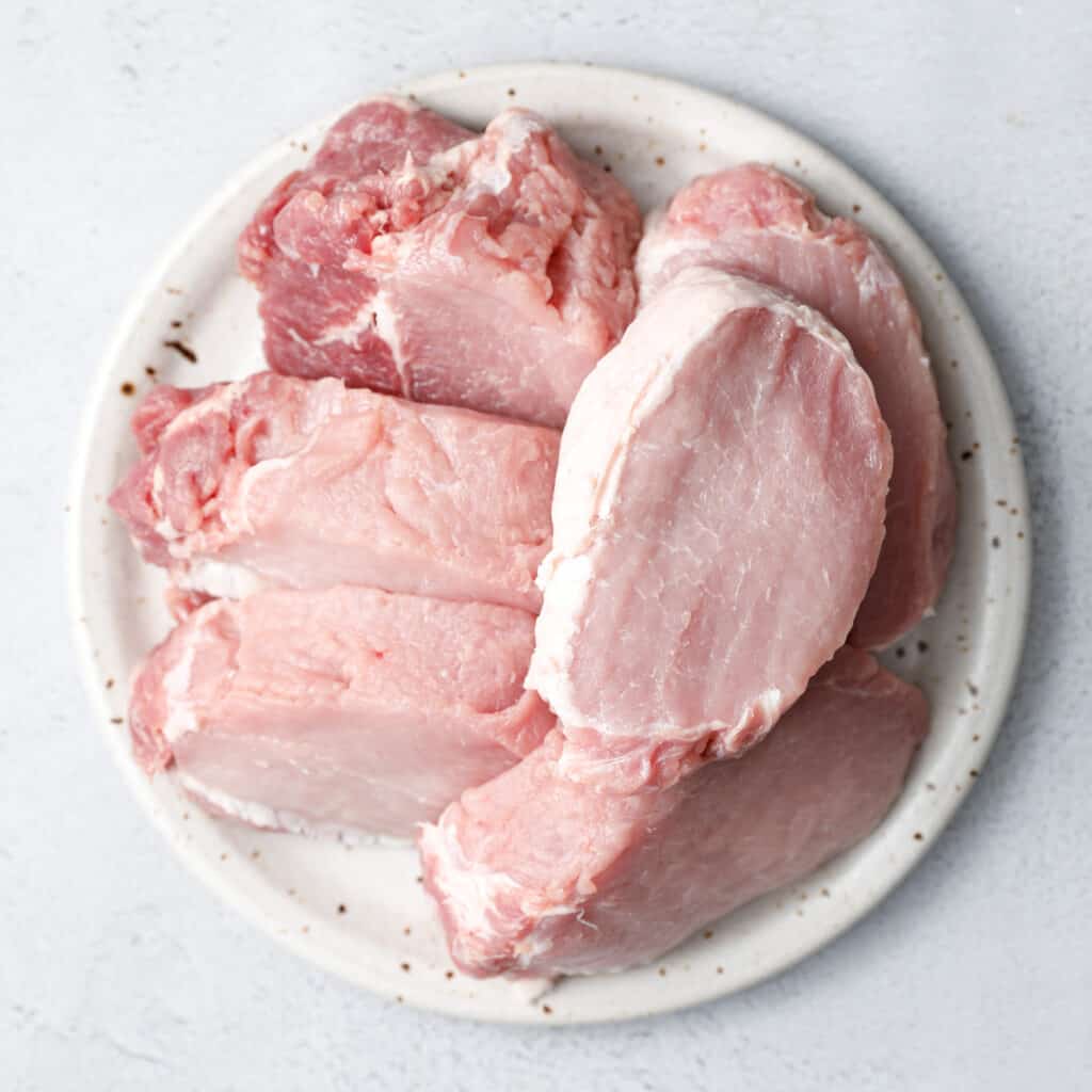 plate of sliced pork ready to be cooked