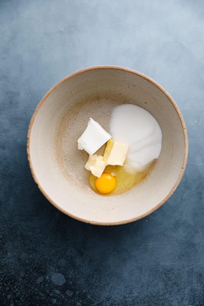 bowl with egg, butter, shortening and sugar ready to make snickerdoodle muffins