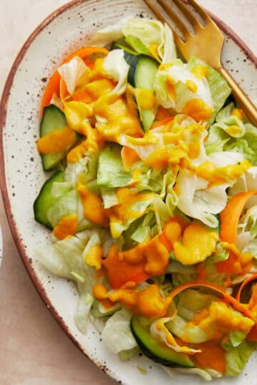 Simple lettuce salad with Japanese style ginger dressing on a platter