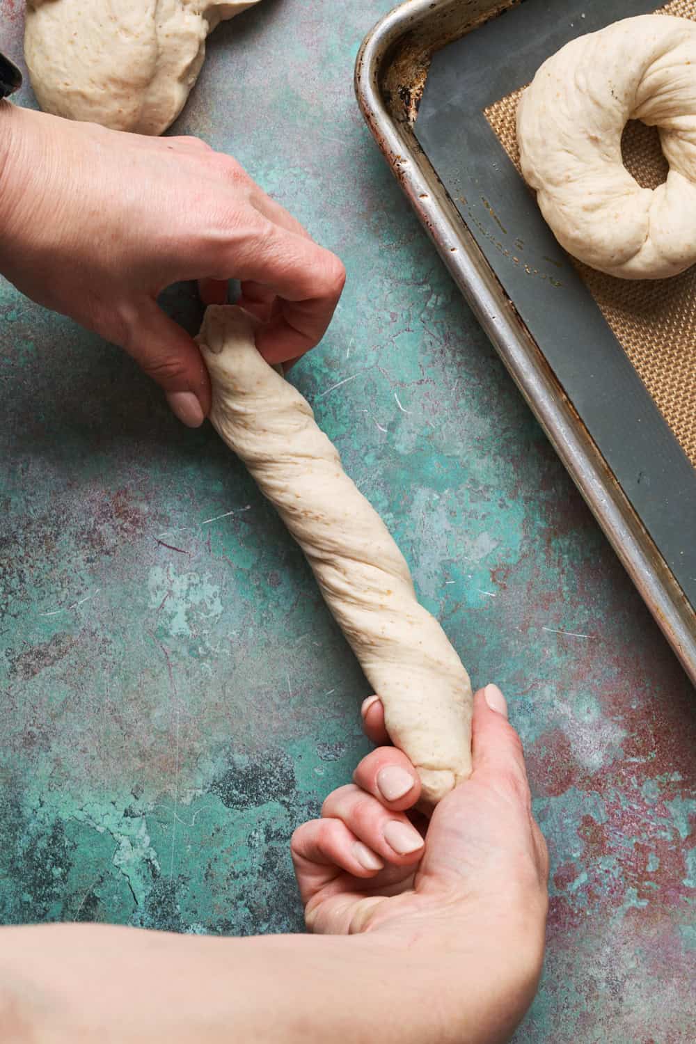 Twisting dough into ropes for forming bagels
