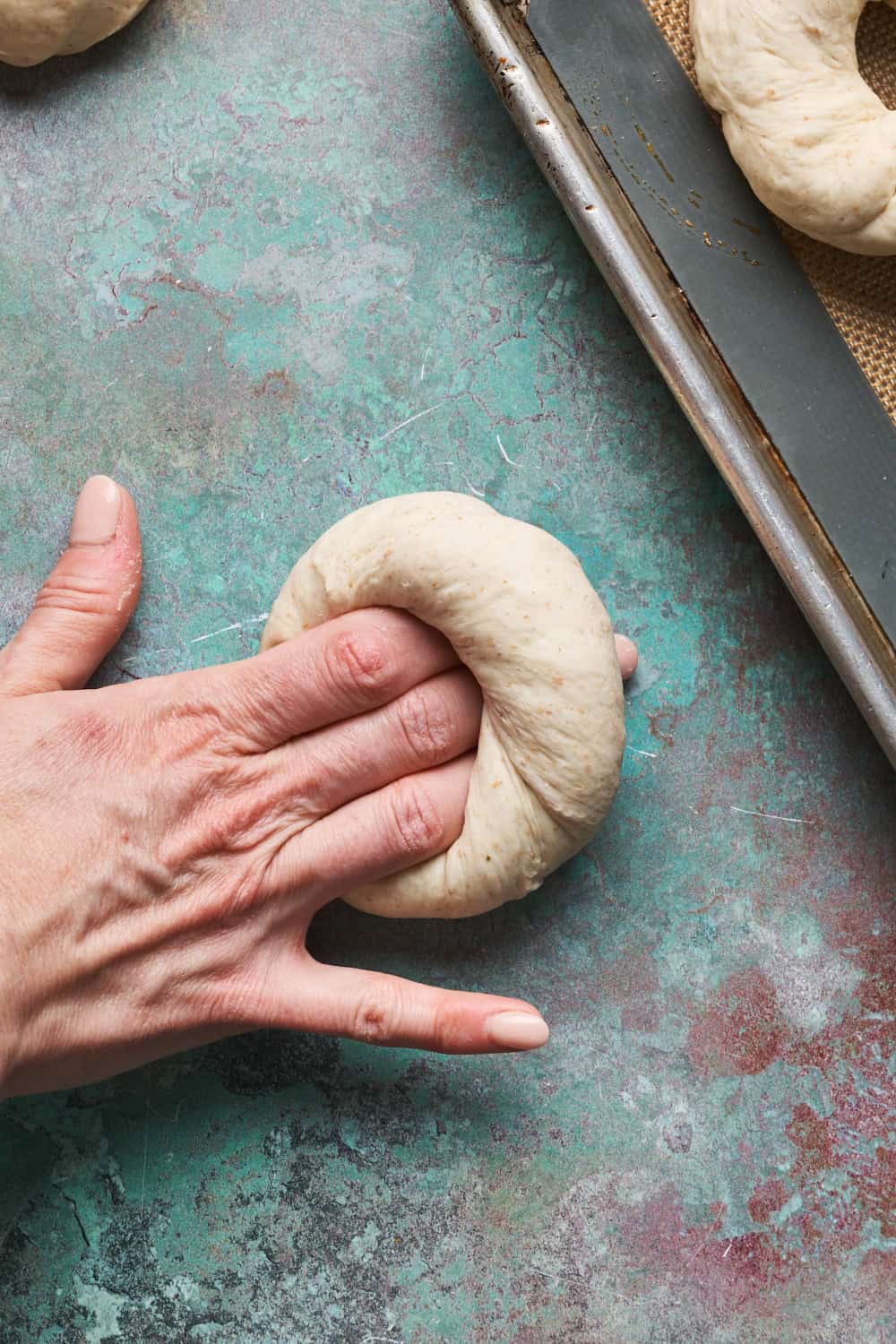 Bagels being formed by rolling