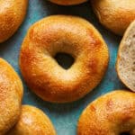 overhead view of sourdough discard bagels on a green background