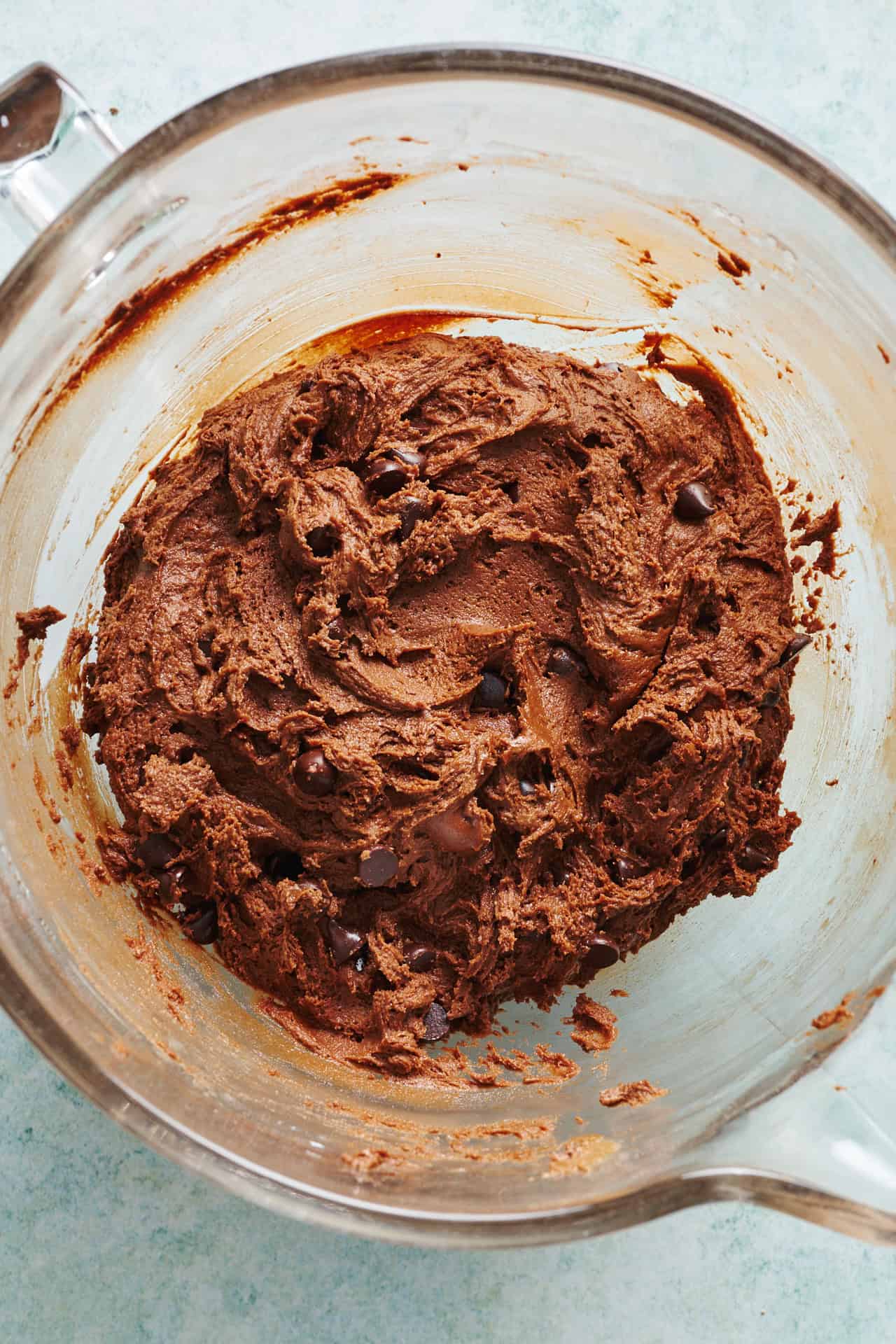 overhead view of the cookie dough ready to be scooped from a glass bowl