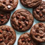 Overhead view of double chocolate chip cookies on a blue background