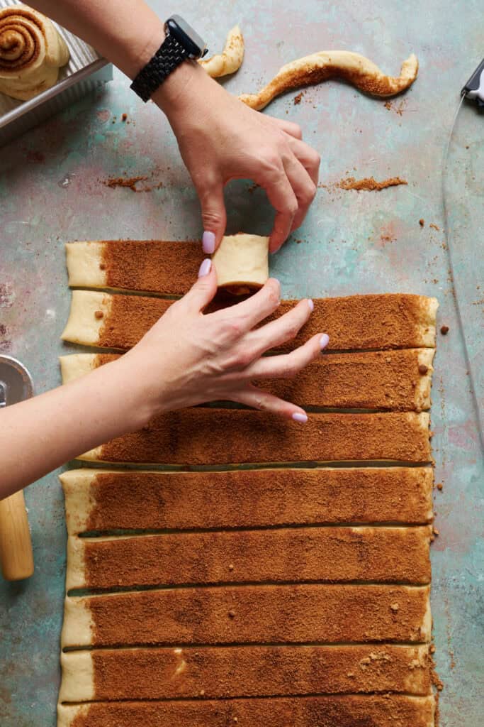 rolling up cinnamon rolls