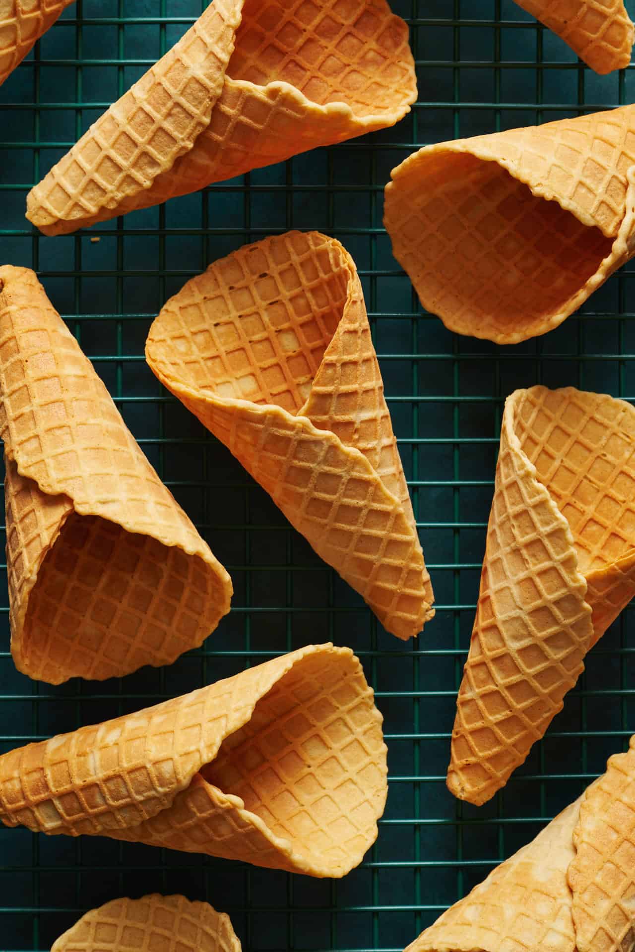 Overhead view of waffle cones cooling on a rack