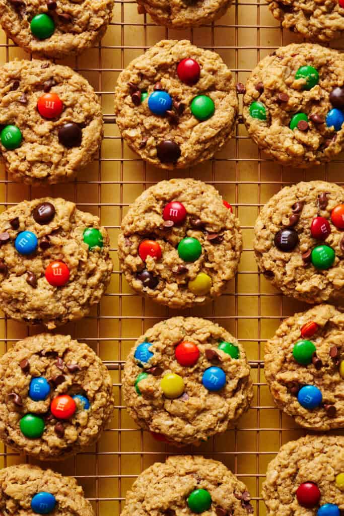 Overhead view of monster cookies cooling on a rack