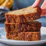 stack of slices of banana bread being picked up
