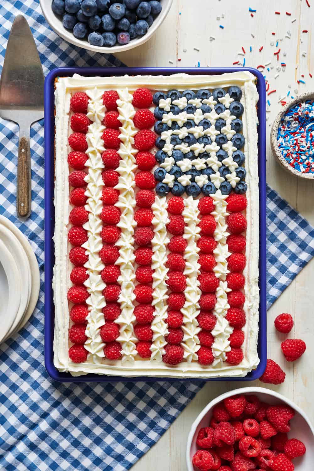 overhead view of a sheet cake decorated with fruit to look like the American flag