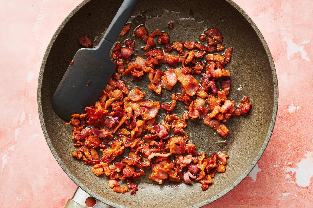 bacon bits frying in a pan