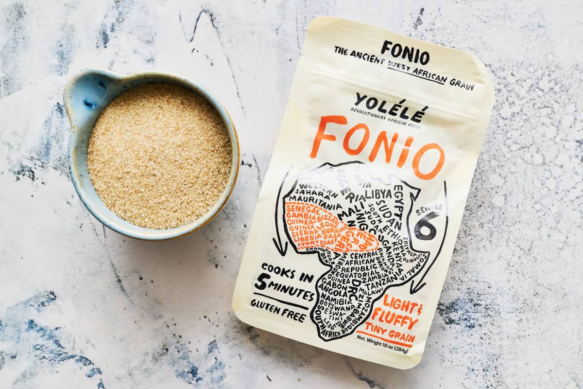 a bag of fonio along with dry uncooked fonio in a small bowl