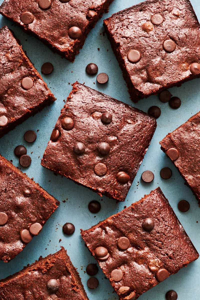 closeup of sliced brownies with chocolate chips scattered around