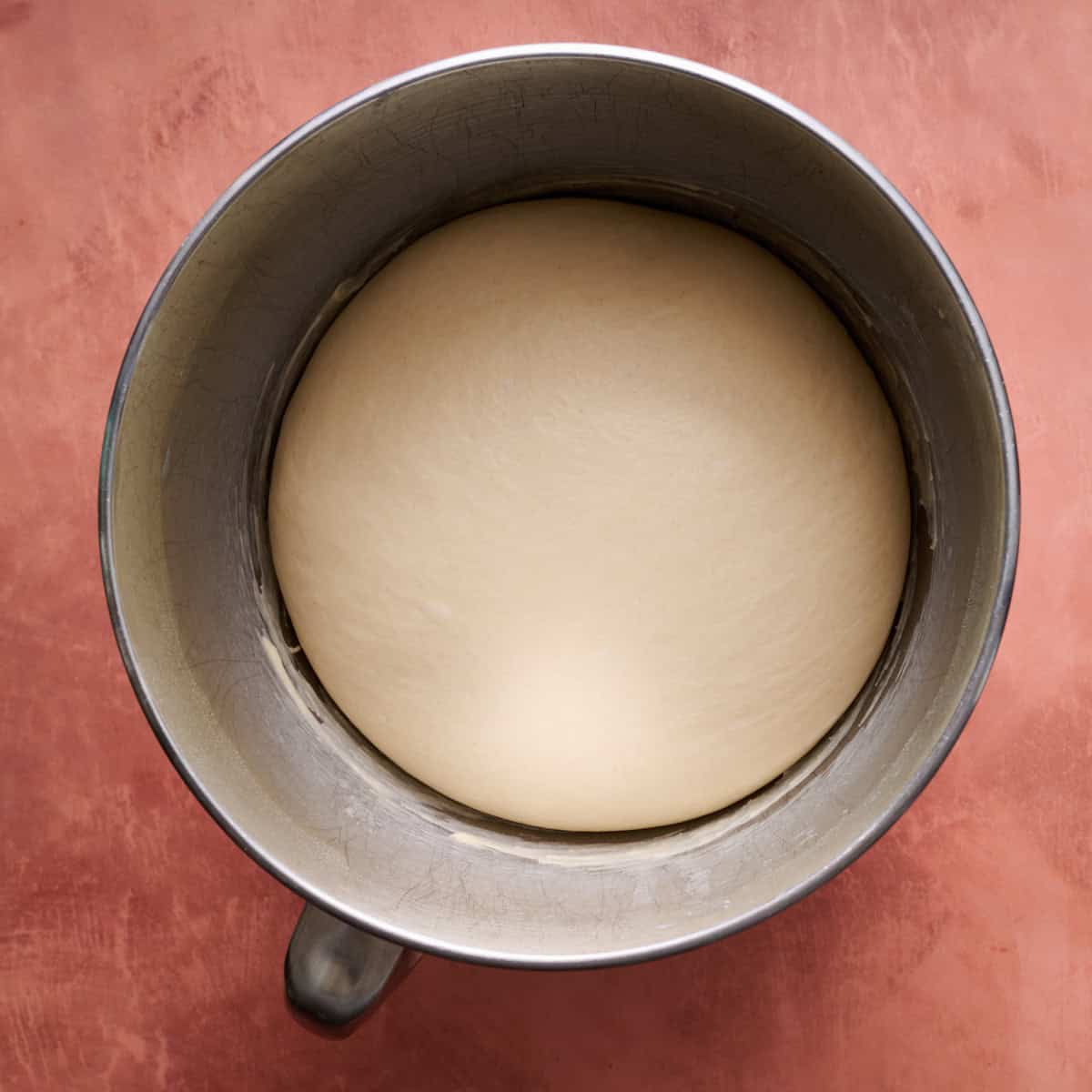 the dough in a bowl after doubling in size