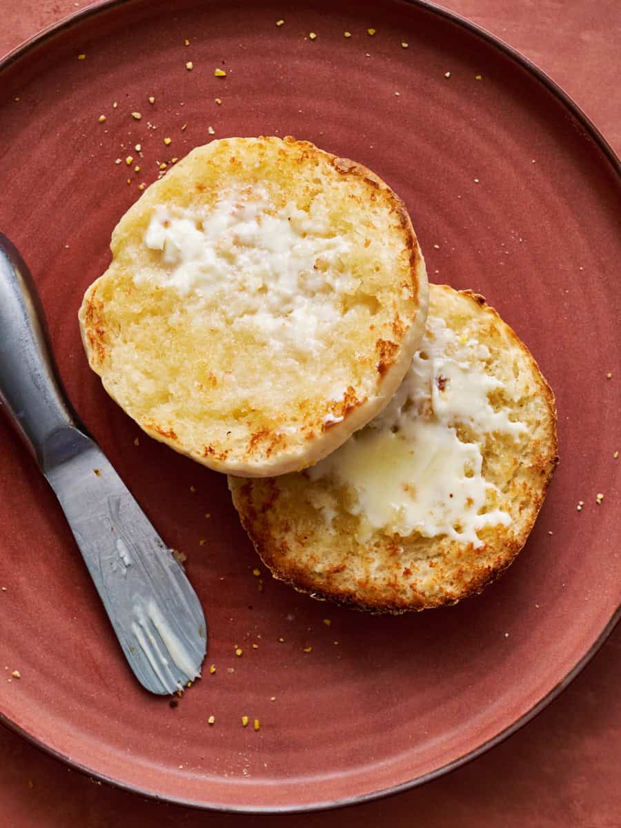 an english muffin split in half, toasted and smeared with butter