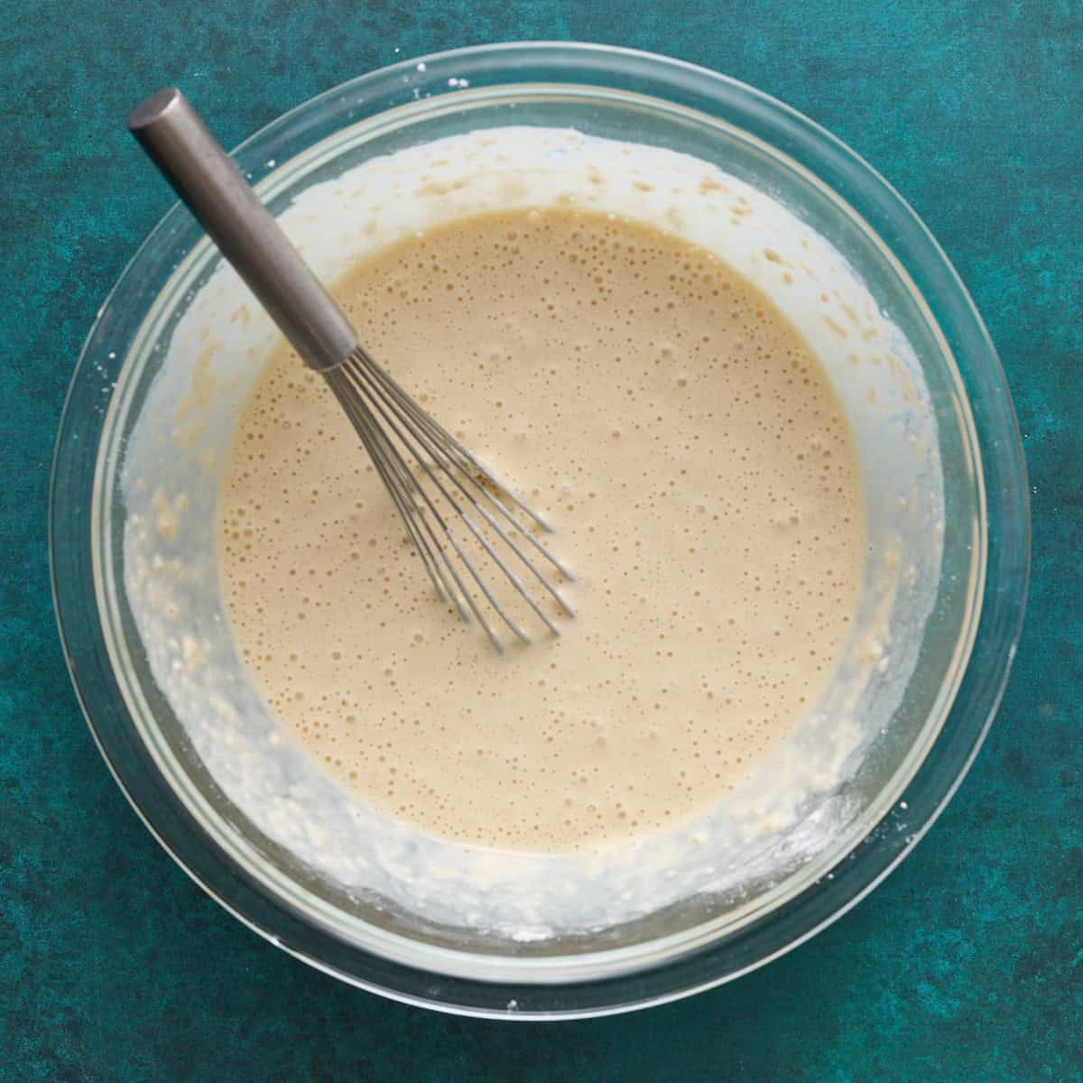 wet and dry ingredients combined in a glass bowl