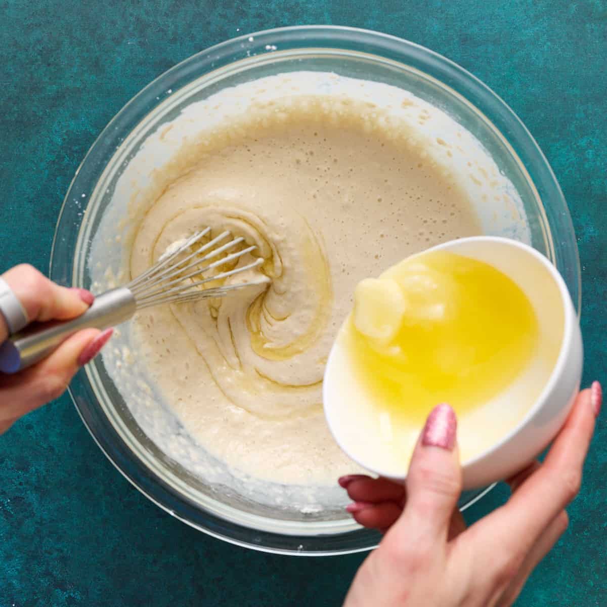 whisking butter into the batter