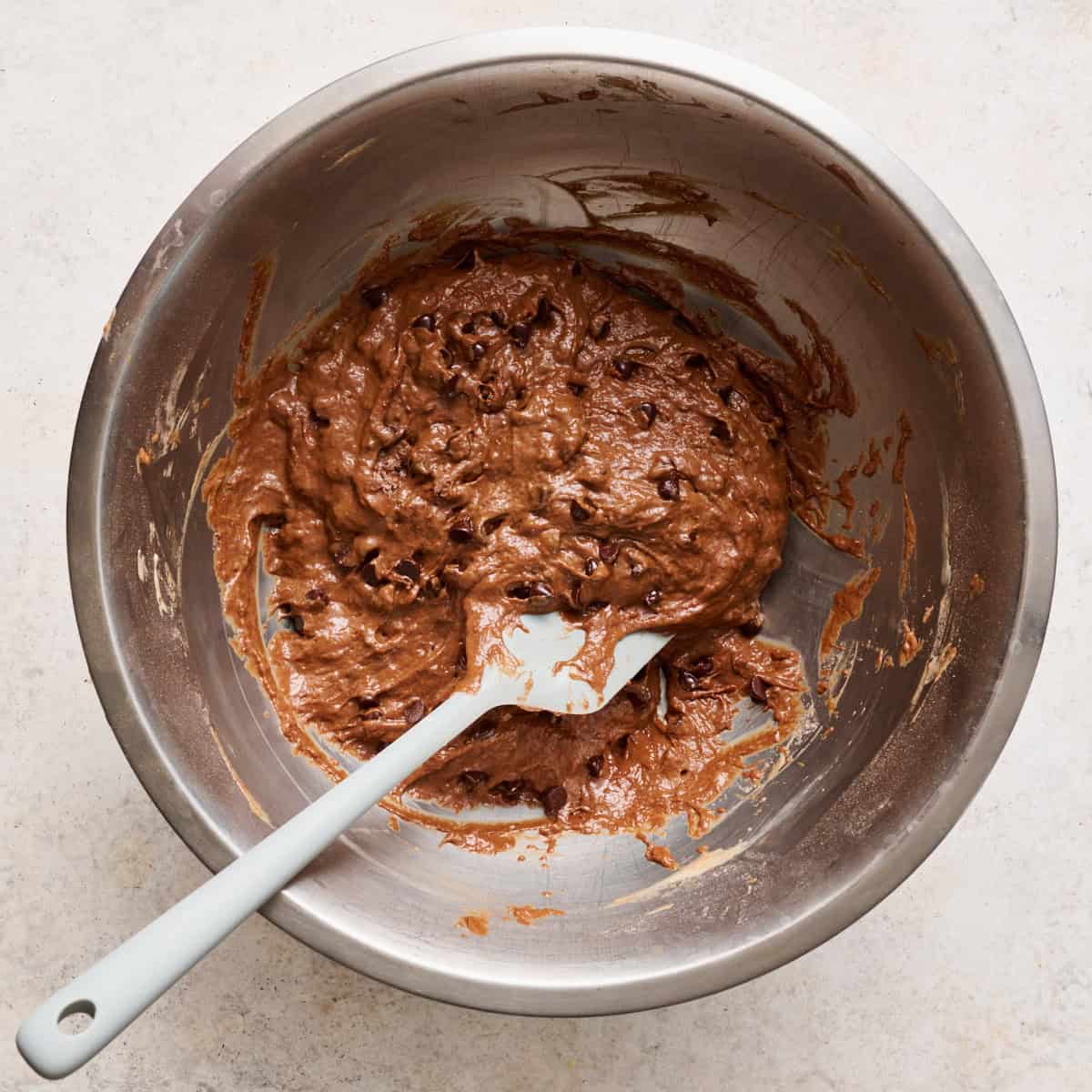 wet and dry ingredients combined to make a batter in a large mixing bowl