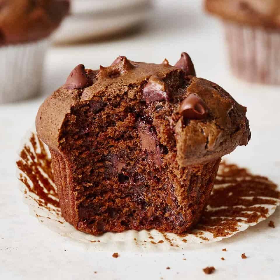 a sourdough chocolate muffin with a bite taken out
