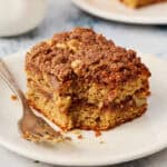 a slice of coffee cake on a plate with a fork