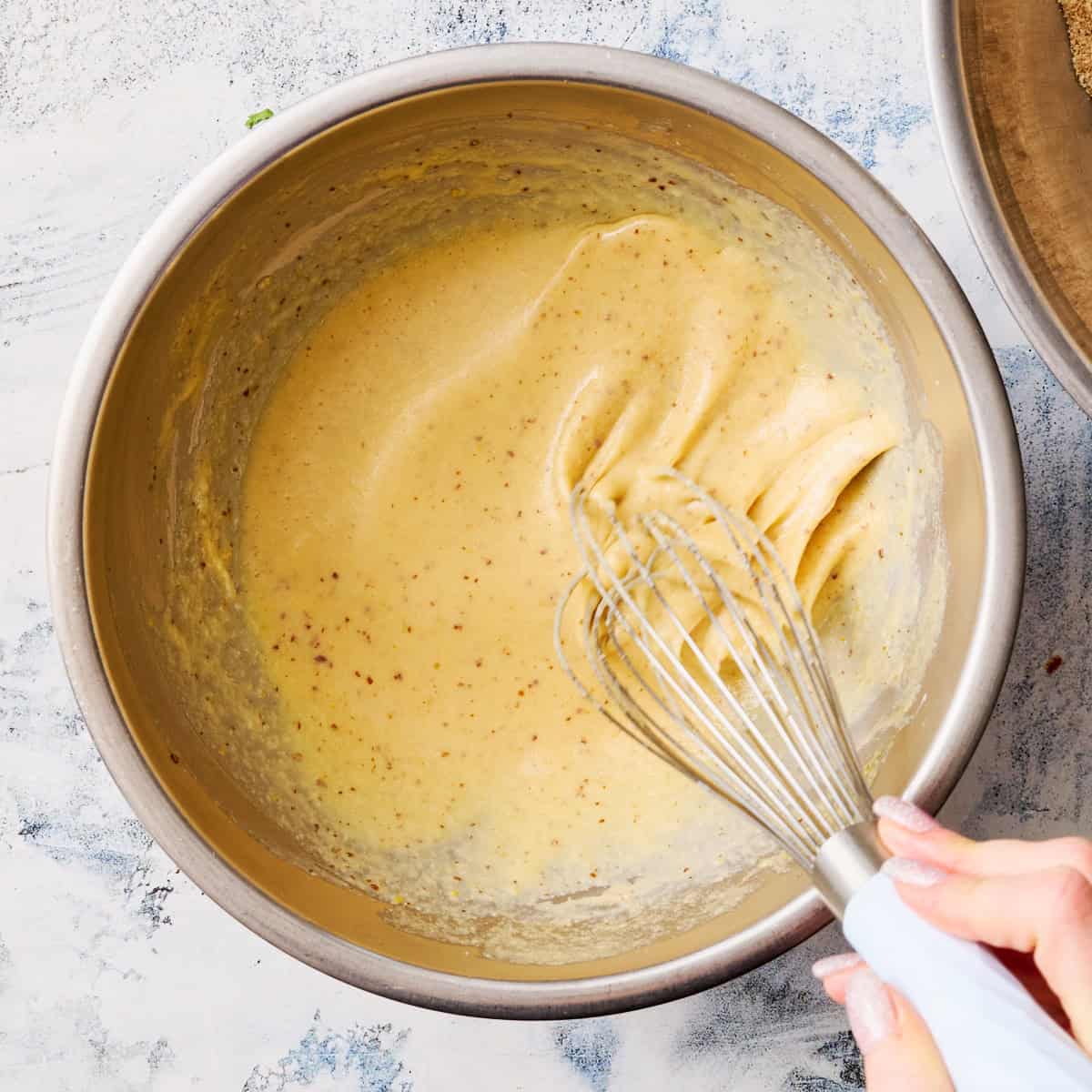 whisking together the wet ingredients for the cake batter