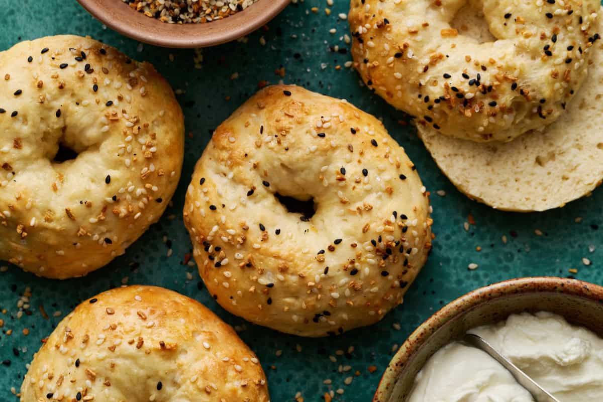 Golden brown baked cottage cheese bagels on a green surface