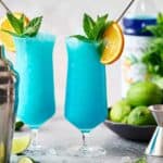 finished garnished Blue Ocean Mocktail drink with orange and mint