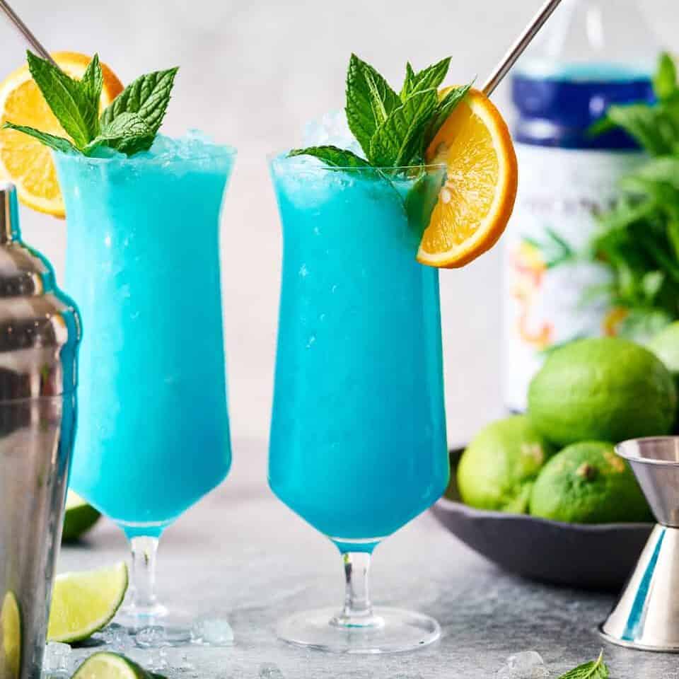 finished garnished Blue Ocean Mocktail drink with orange and mint