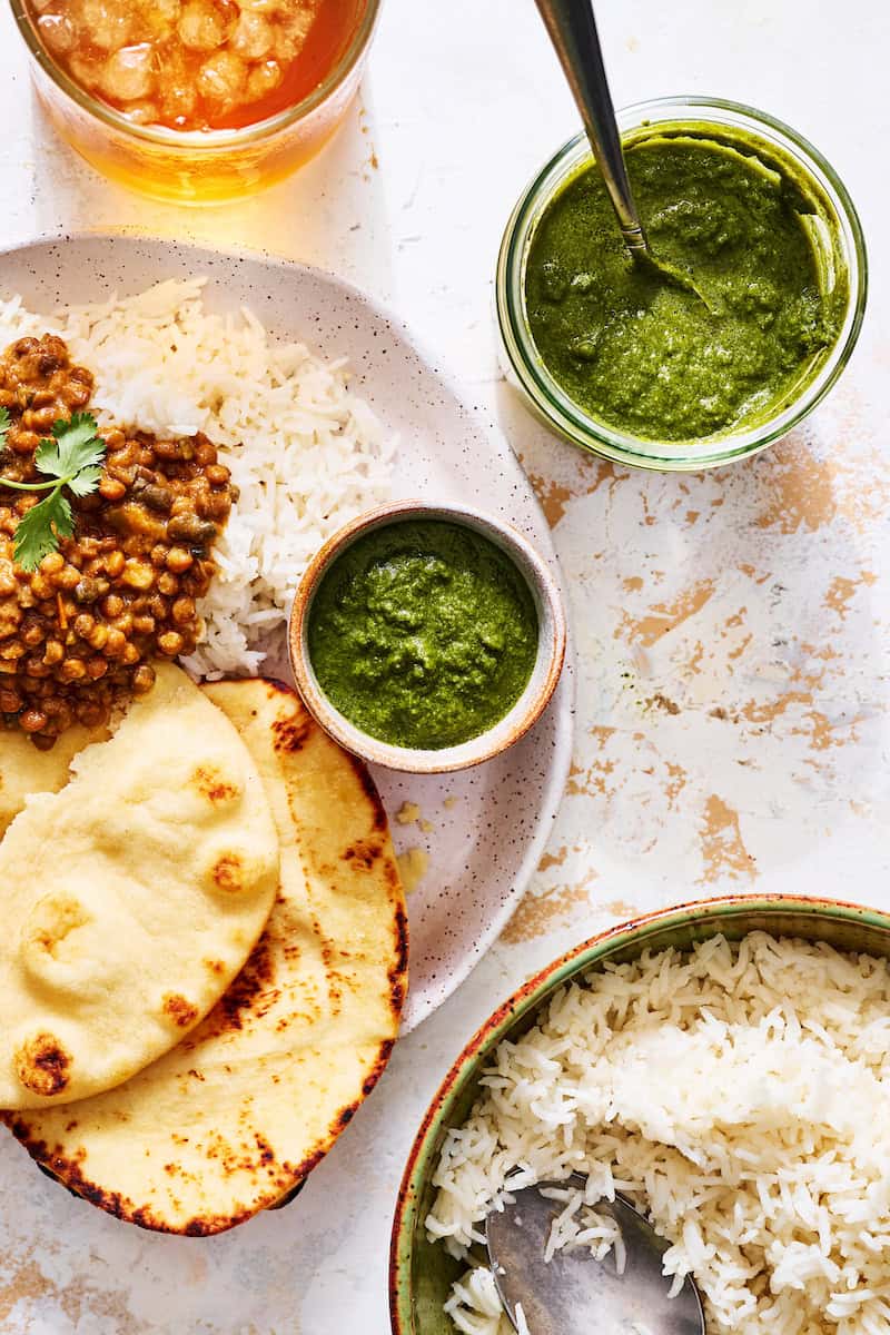 spread of Indian food with cilantro mint chutney