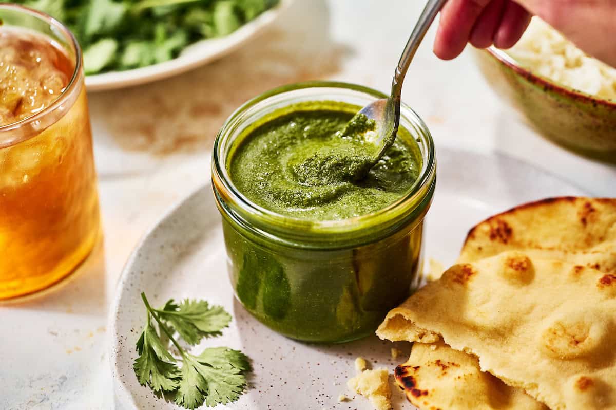 green chutney in a glass jar with naan bread