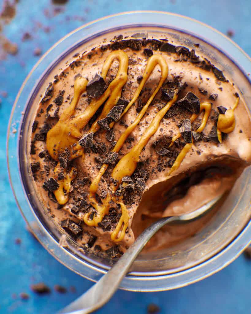 closeup image of protein ice cream with peanut butter drizzle and chocolate chips.