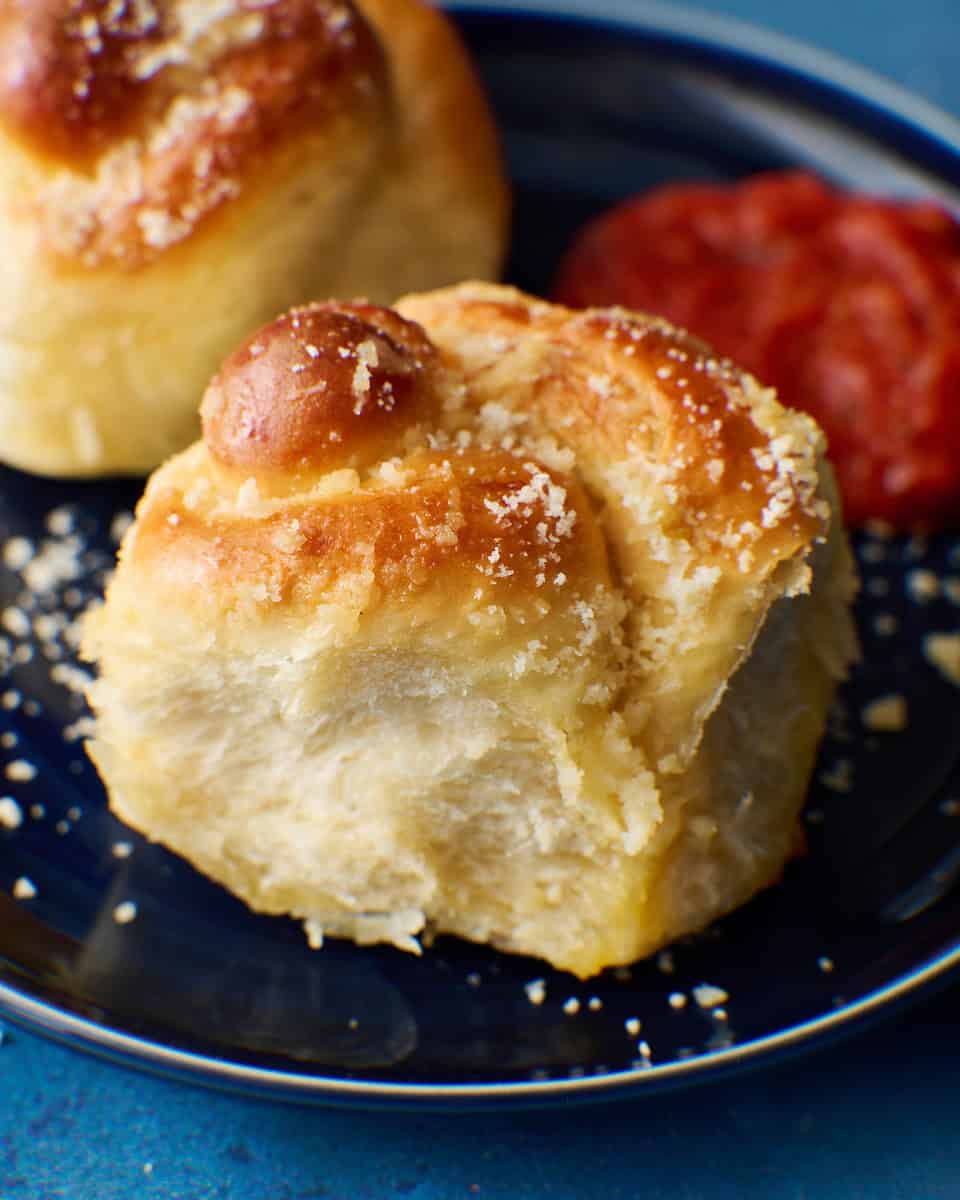 garlic knot roll on a plate with marinara