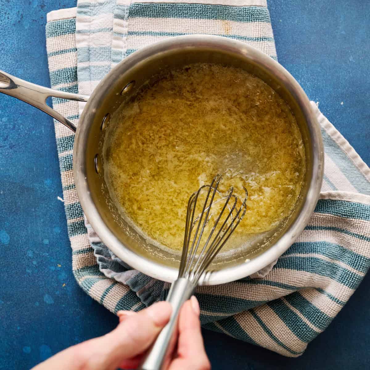 mixing garlic, garlic powder, salt and butter in a saucepan