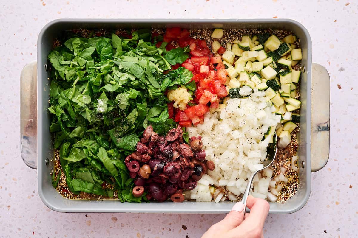 all of the vegetables added on top of the quinoa mixture ready to be mixed