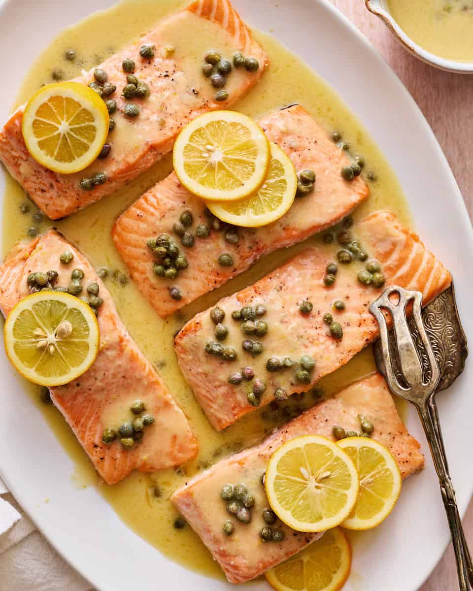 salmon piccata with capers and garnished with fresh lemon