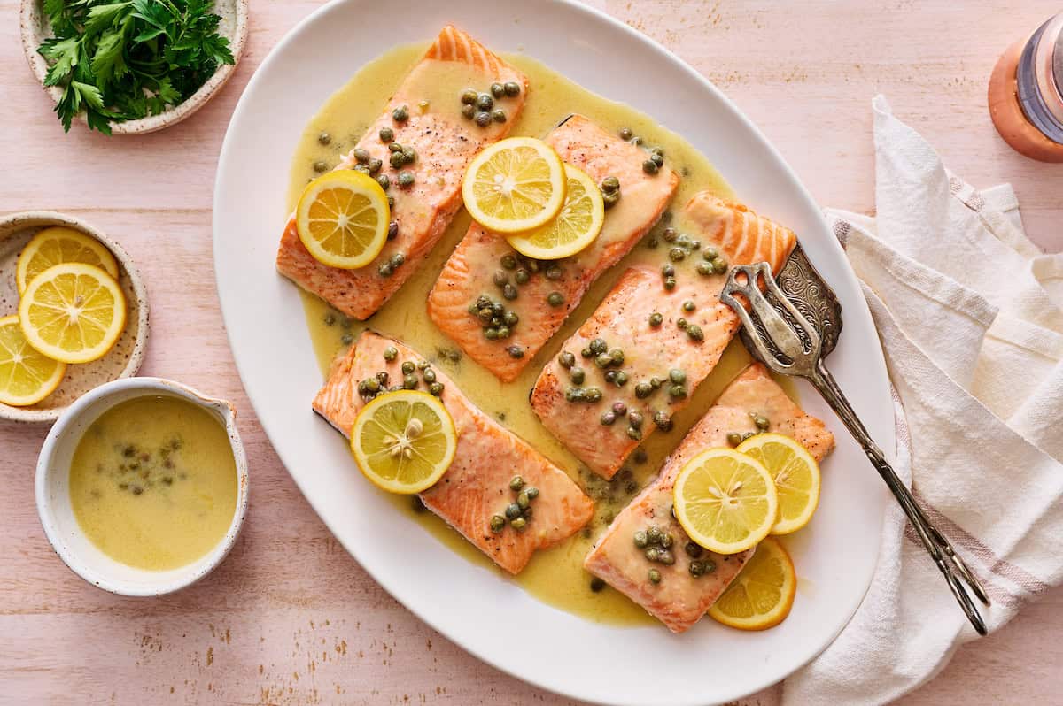 salmon piccata with capers and garnished with fresh lemon