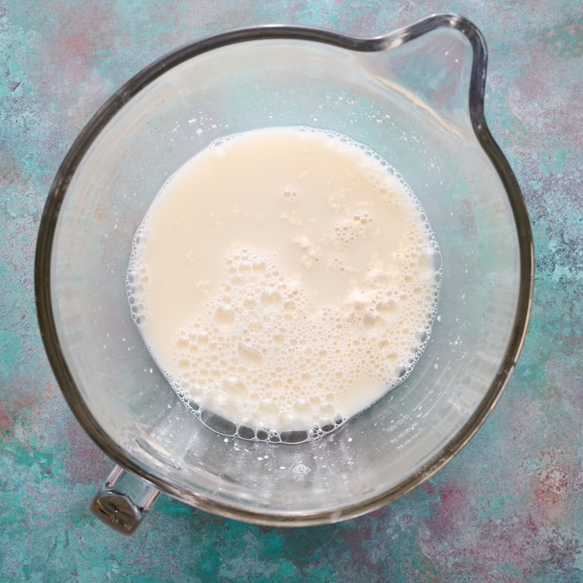 sourdough starter, water and honey combined in a mixing bowl