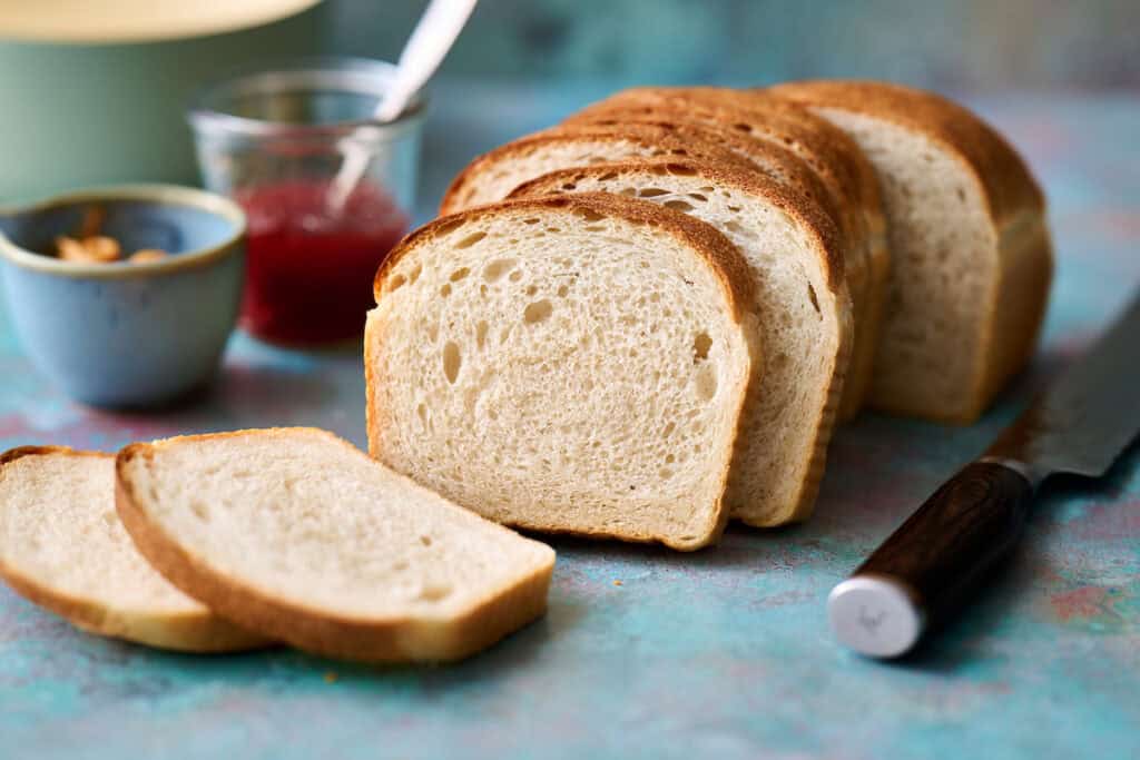 sandwich bread sliced with a bread knife