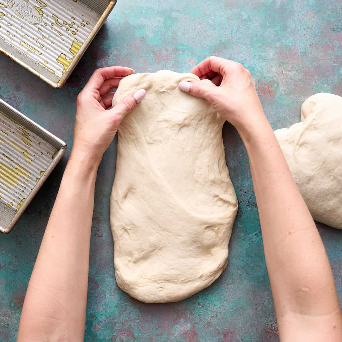stretching out the dough to form the loaf