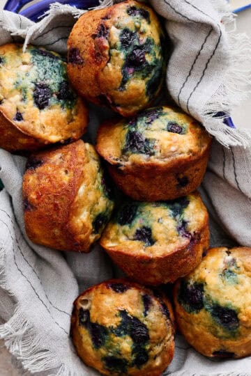 Cottage Cheese Blueberry Muffins stacked in a blue serving dish