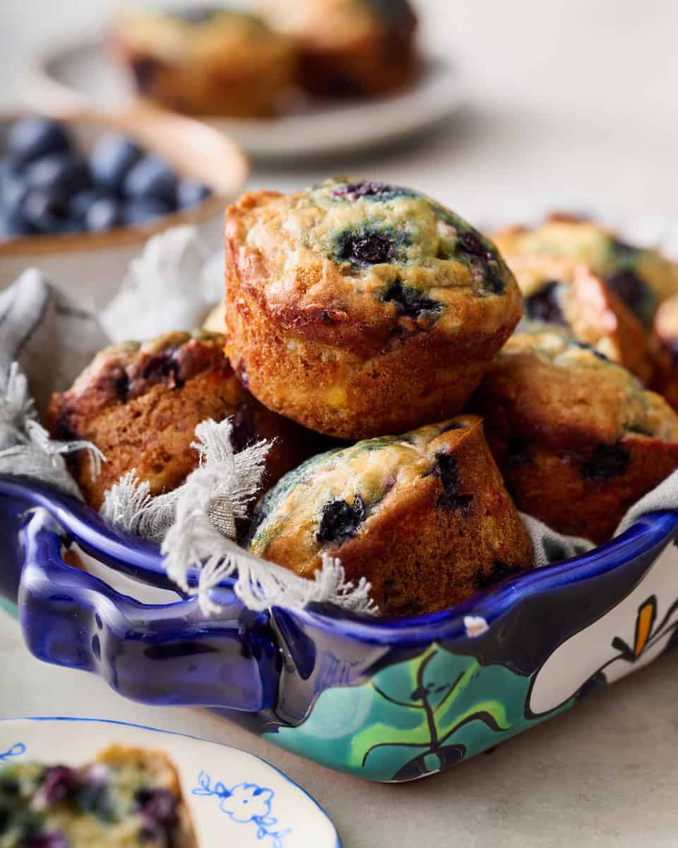 Cottage Cheese Blueberry Muffins stacked in a blue serving dish