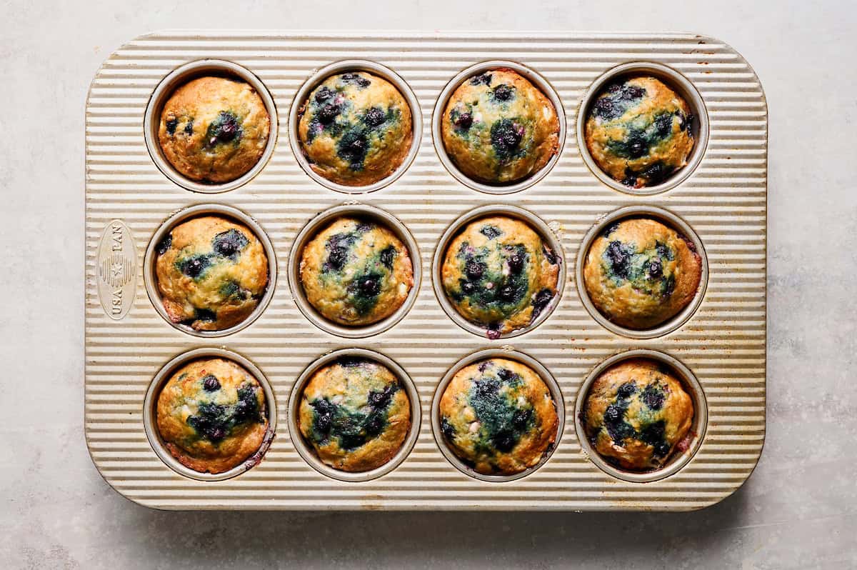 blueberry muffins in a tin fresh out of the oven