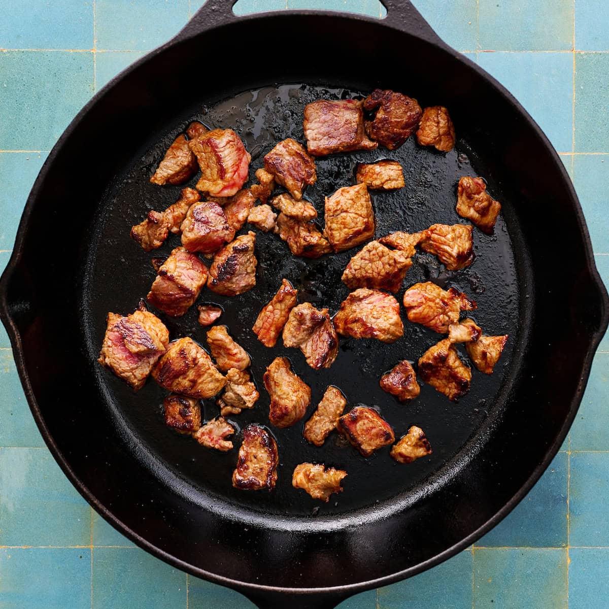 searing beef in a cast iron skillet