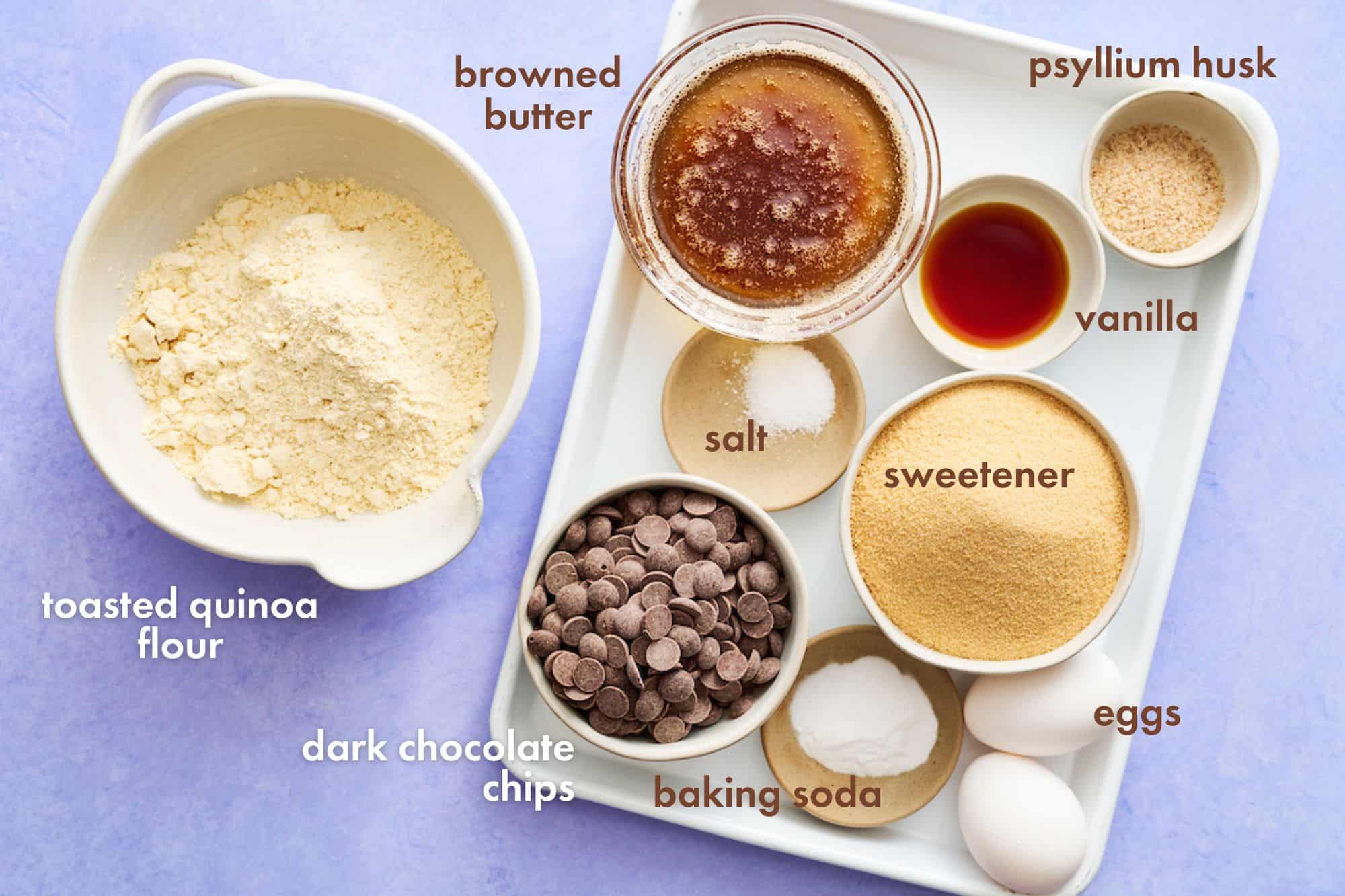 ingredients for making sugar free chocolate chip cookies arranged on a white baking tray