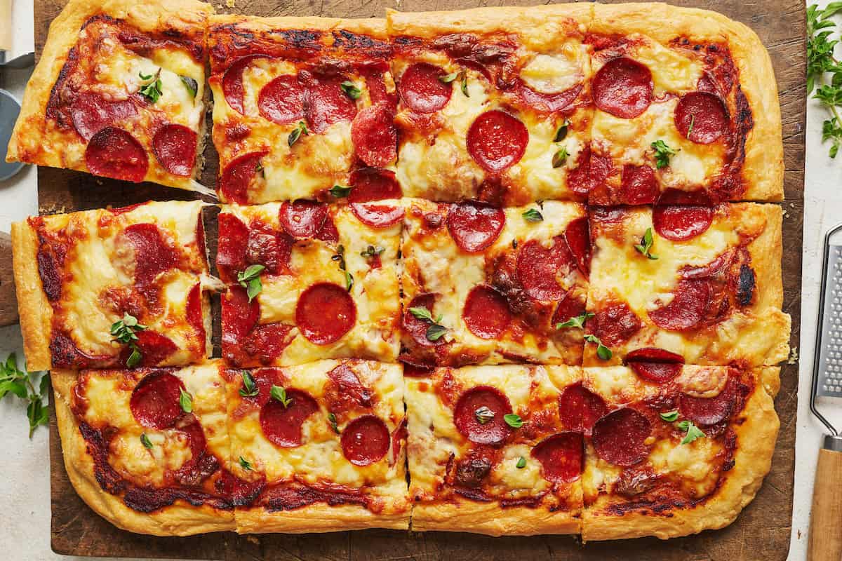 pepperoni pizza on a wood cutting board