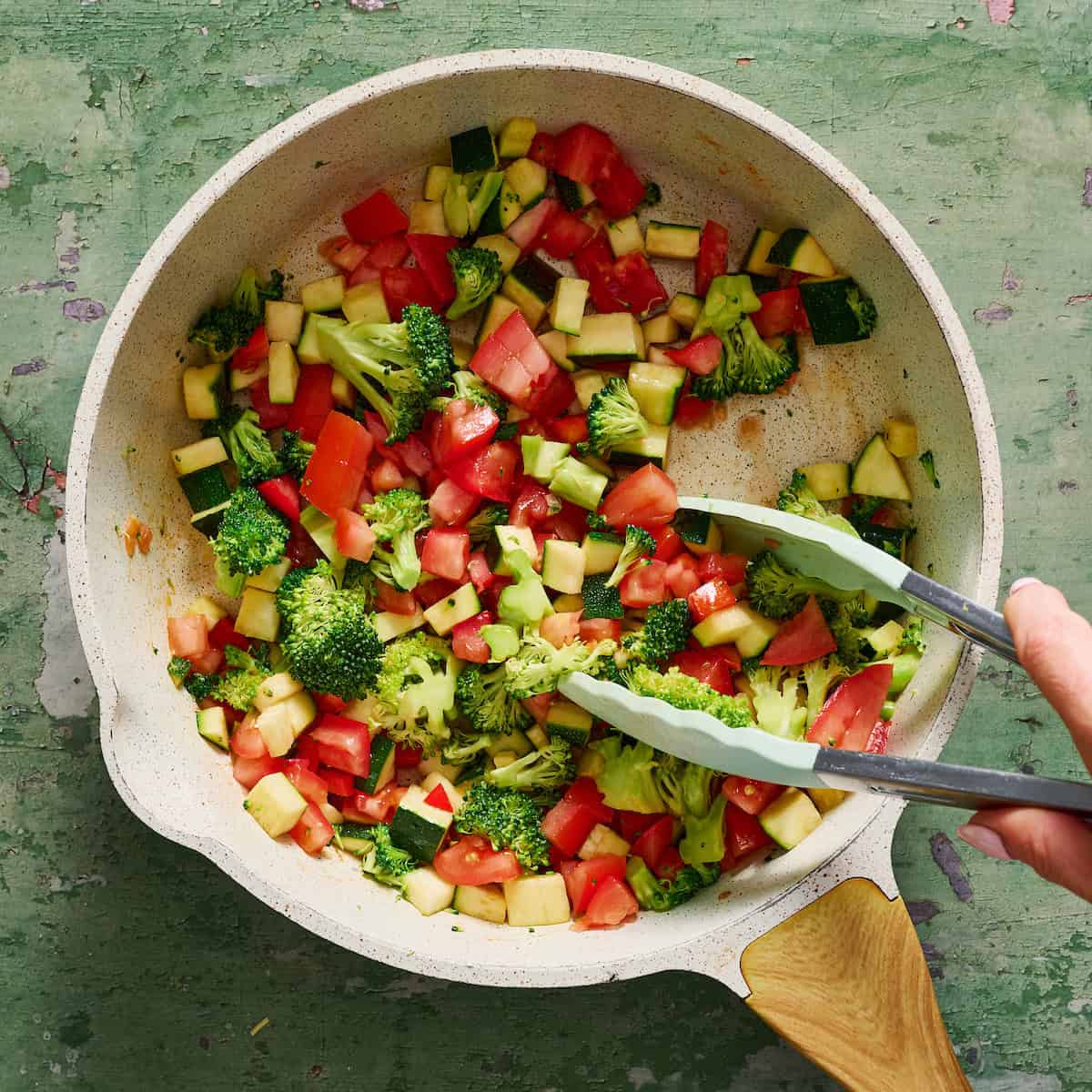 sauteing vegetables in a pan with oil