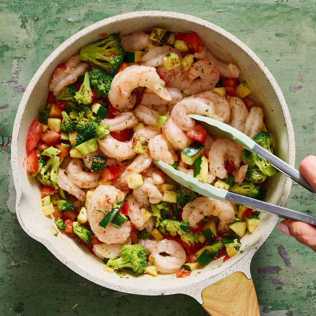 shrimp added to a pan with vegetables